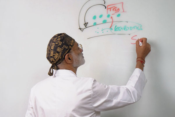Dr.-Pradip-Jamnadas-Writing-on-White-Board